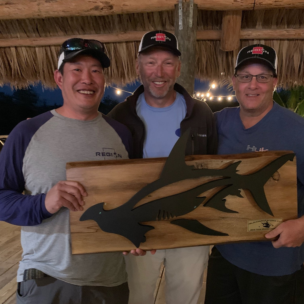 Mark Yamasaki, Captain Chris Daly and Ron Lesseraux holding the 2019 Islamorada Shark Fly Tournament Team Grand Champion trophy